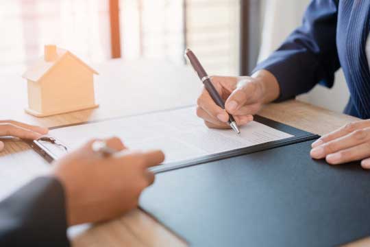 Self-employed person signing mortgage agreement